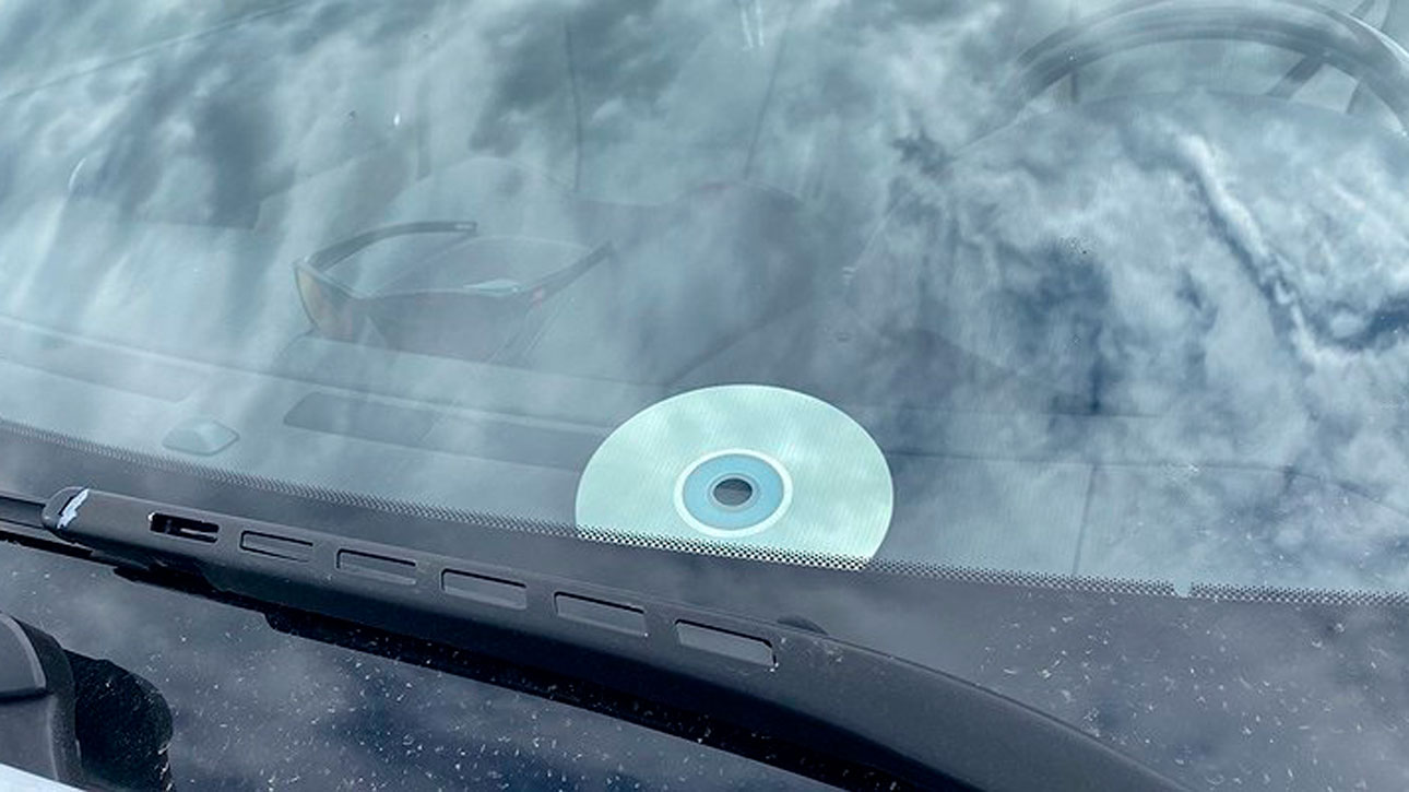 Почему водители кладут под лобовое стекло перевернутые диски?