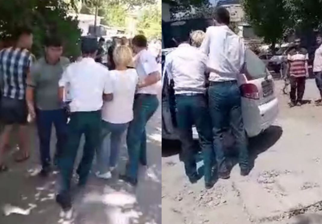 В Ташкенте сотрудники правоохранительных органов затолкали в машину женщину, пытавшуюся защитить незаконно установленный гараж